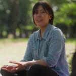 woman sitting outdoors chatting with a friend - group support